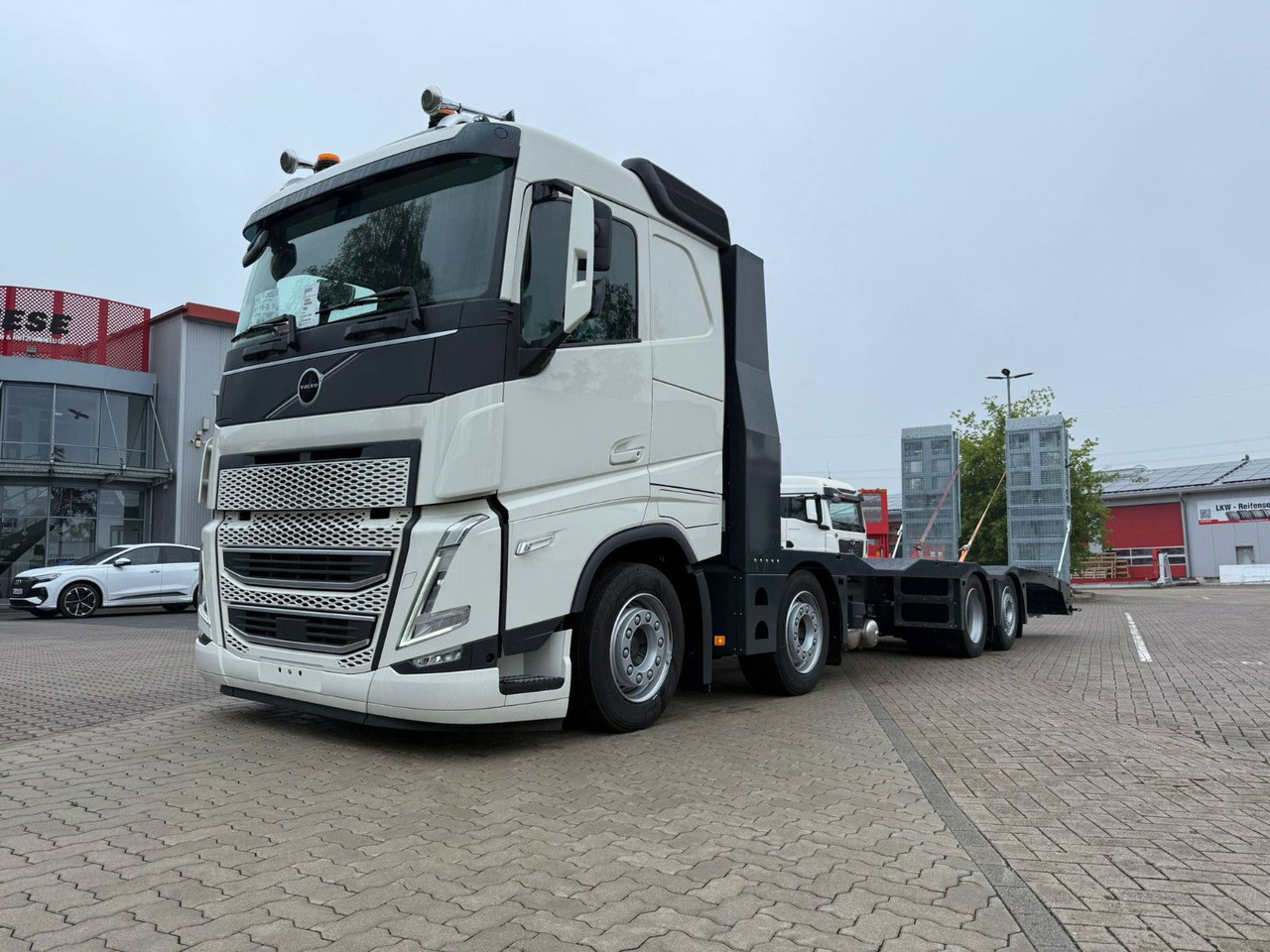 Volvo Arbeitsbühnen Baumaschinentransporter mit Rampen - Dropside/ Flatbed truck: picture 1 Volvo Arbeitsbühnen Baumaschinentransporter mit Rampen - Dropside/ Flatbed truck: picture 1