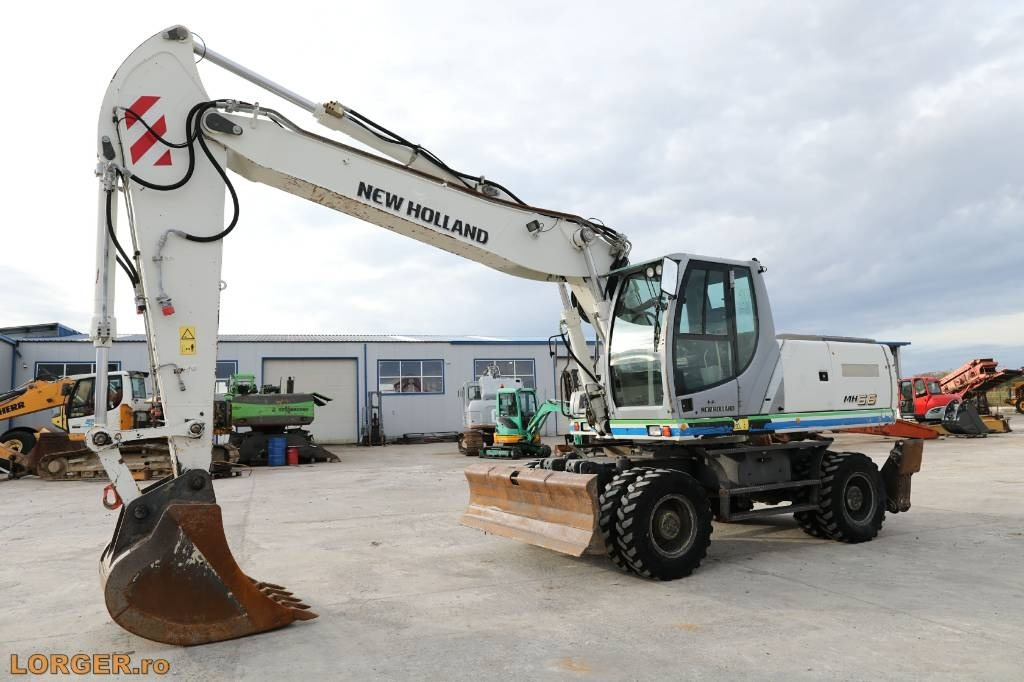 New Holland MH 6.6 + Sandvic Hammer - Wheel excavator: picture 1 New Holland MH 6.6 + Sandvic Hammer - Wheel excavator: picture 1